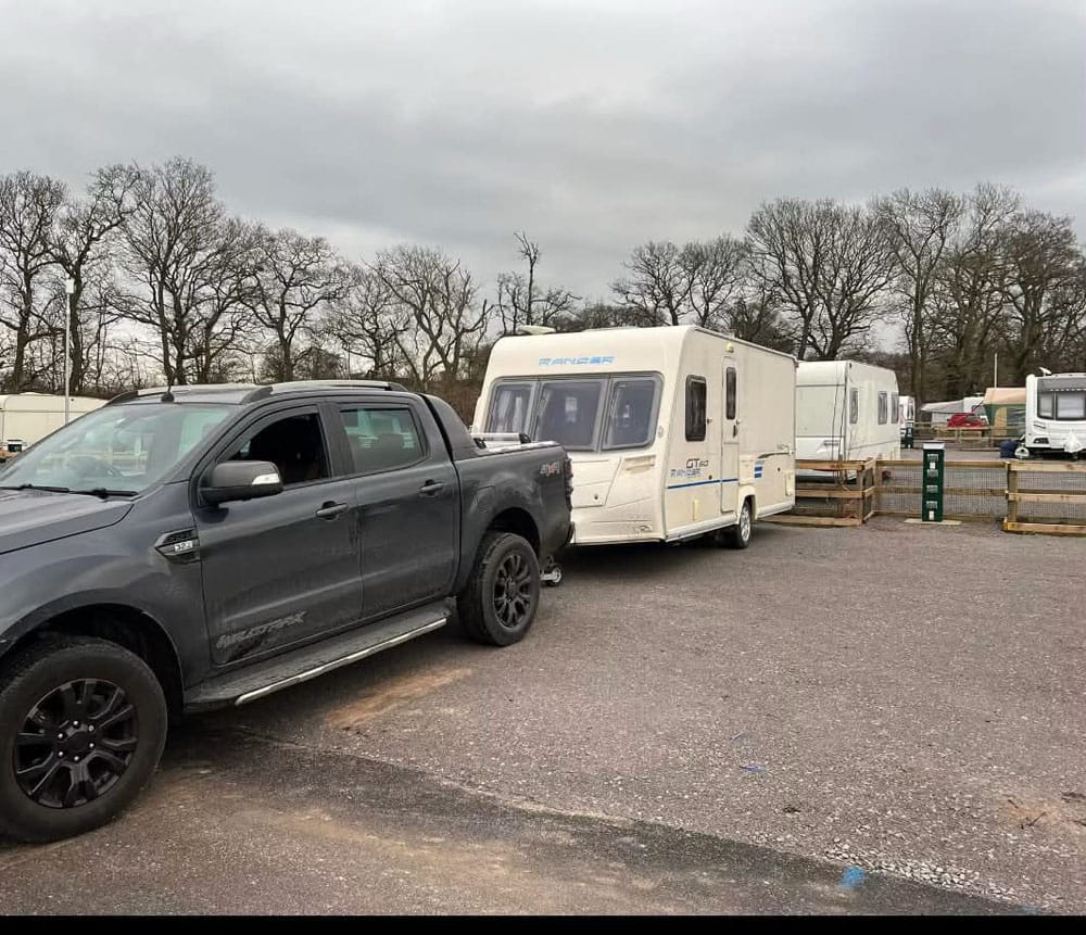 Bailey Ranger GT60 touring caravan hitched to a pickup truck for collection at a caravan storage site